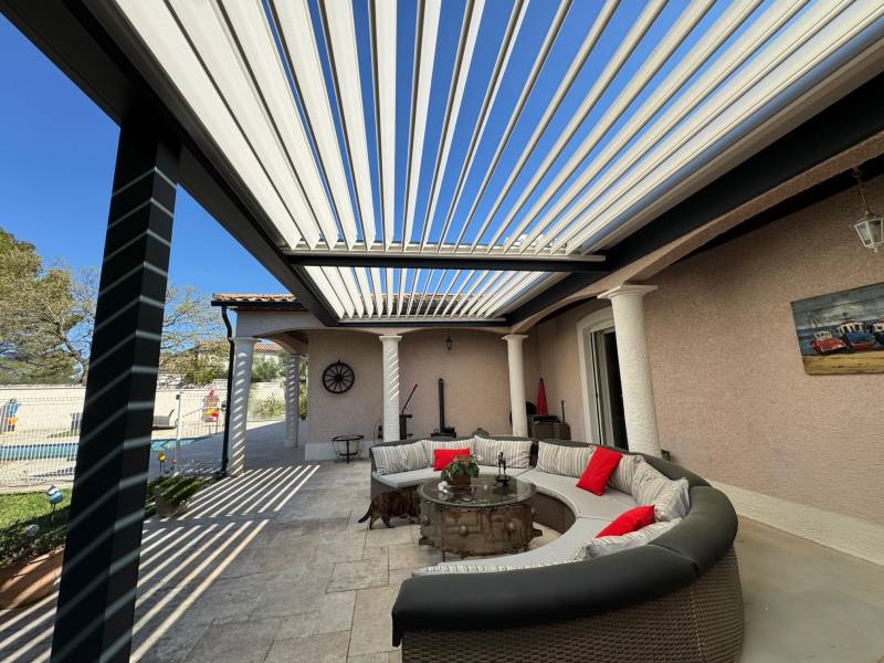 Réalisation d'une pergola bioclimatique adossée fabriquée sur mesure et installée à Nîmes dans le 30